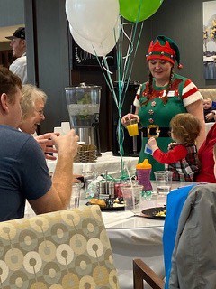 This is a photo of an elf handing with family members
