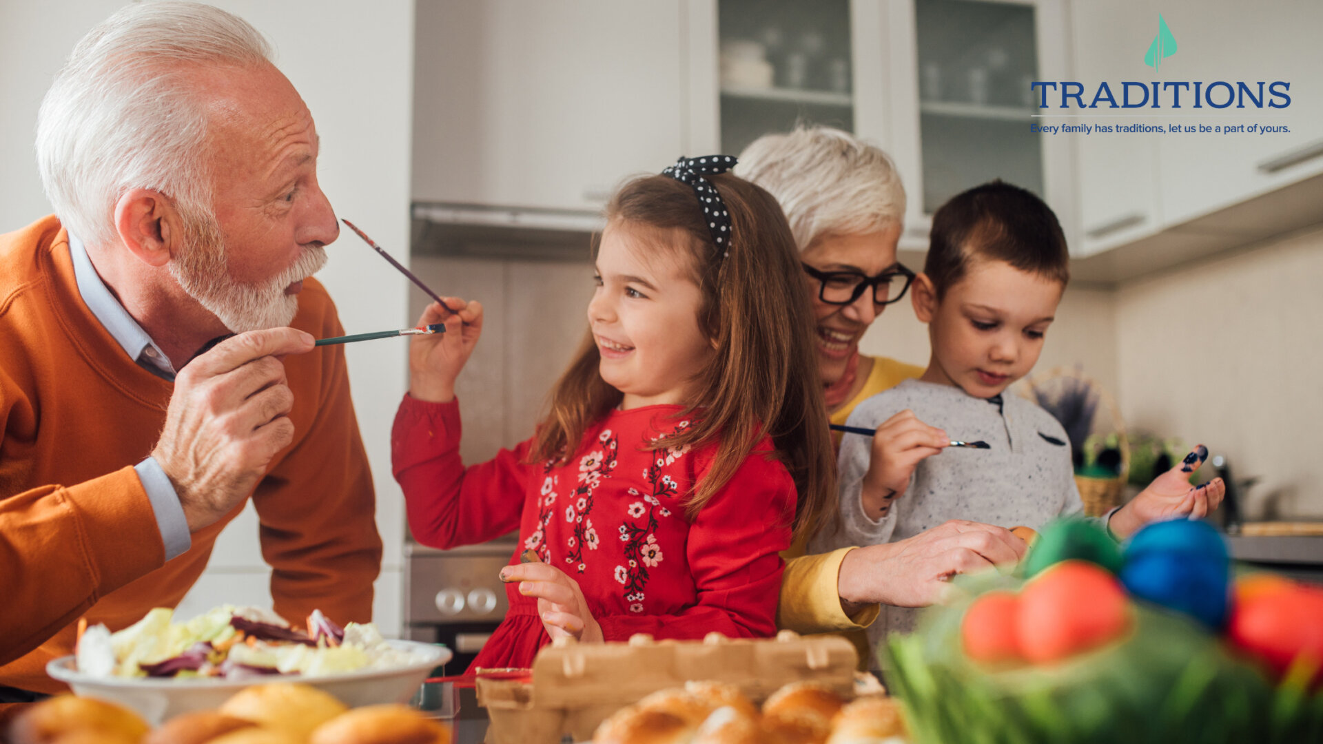 Two elderly people paint and play with their grandkids in the kitchen