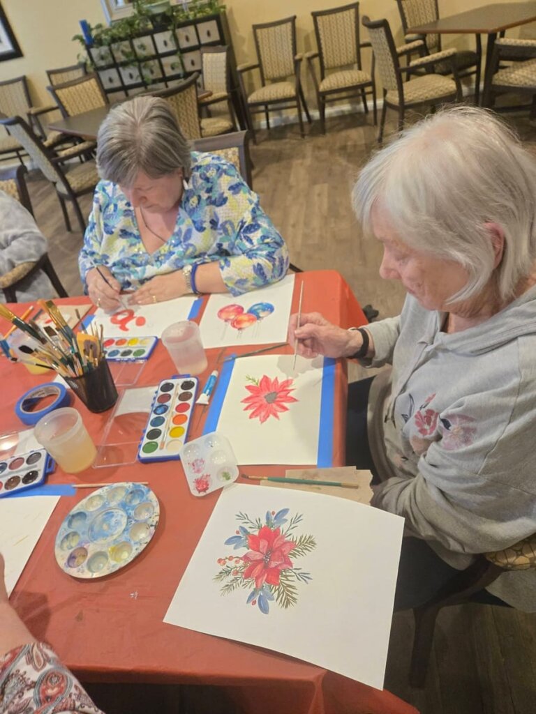 Residents painting watercolor artwork together at Meadow Brook Senior Living