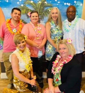 This is a photo of the Meadow Brook staff in their luau gear
